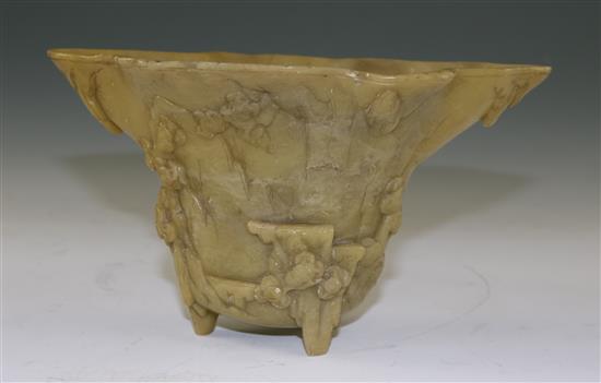 A Chinese pale green soapstone libation cup, 19th century, width 18.5cm, height 10cm, faults